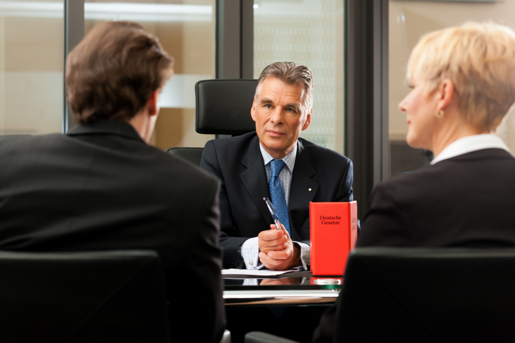 businessman with partner talking to a lawyer